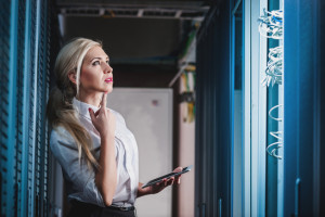 Young engineer in network server room